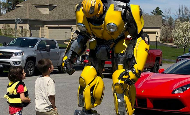 Life sized yellow transform with a boy and a girl